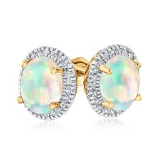 The shimmering color play in the oval shaped opal gemstones presents itself as an alluring focus in this beautiful earring style. The opal gemstones glisten with iridescent color among a halo of sparkling round diamonds set in 10k yellow gold. Diamonds are 1/6ctw, I or better in color, and I2 or better in clarity. These earrings measure 10mm in length and 9mm in width. Yellow Gold Oval Opal Earrings, Oval Opal Earrings In Yellow Gold, Formal Oval Opal Earrings, Oval Opal Earrings For Formal Occasions, Yellow Gold Stud Earrings, Iridescent Color, Round Diamond Setting, Color Play, Gold Stud Earrings