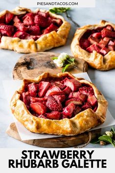 three pies filled with strawberries on top of a table