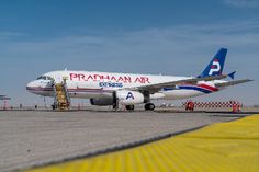 an airplane sitting on the tarmac at an airport