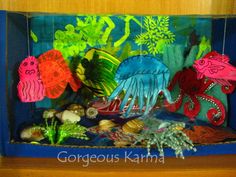 an ocean scene made out of paper with sea animals and corals in the background