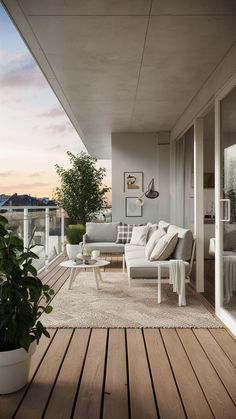 a living room filled with furniture on top of a wooden floor next to a balcony