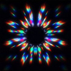 an abstract image with bright lights in the center and black background, showing multicolored lines