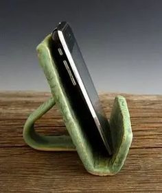 a cell phone in a holder on a wooden table