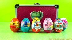 an assortment of decorated eggs sitting in front of a pink case