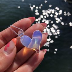 "One of a kind ocean inspired borosilicate glass heart necklace in a gorgeous Ghost slightly transparent and iridescent colour. Definitely the most versatile wearable piece in the glasea collection. The colour sparkles even more with brighter colours. Approximately 1\" x 1\" Pendant comes with a sterling silver stamped 925, 1 mm snake or ball chain. Please select your length at check out.  Sterling Silver chains are made in Italy.  Each piece is completely handmade and is one of a kind. Therefore, sizes are approximate and design is unique and therefore might vary slightly from the photos. Thanks for supporting small! All pieces are hand made in Vancouver, BC, Canada" Unique Iridescent Glass Necklaces, Iridescent Glass Necklaces As Gifts, Glass Heart Pendant Necklace For Gift, Clear Heart Pendant Jewelry For Valentine's Day, Heart-shaped Glass Jewelry For Valentine's Day, Iridescent Heart Pendant Jewelry For Valentine's Day, Iridescent Glass Jewelry As Gift, Heart-shaped Glass Necklaces For Jewelry Making, Iridescent Glass Jewelry Gift