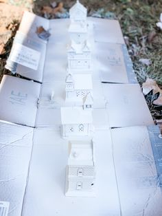 a group of small white houses sitting on top of cardboard