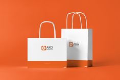 two white and orange shopping bags on an orange background with the tag logo above them