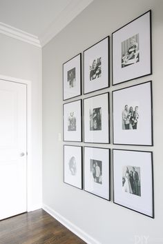 black and white photographs are hung on the wall above a wooden floor in this living room