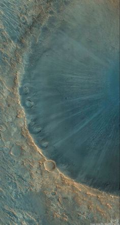 an aerial view of a crater in the desert