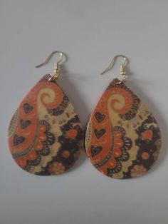 These unique vibrant print sublimation wood earrings come in a variety of shapes and sizes, The designs range from simple patterns to intricate images. They are lightweight, double sided, and comfortable to wear, making them a popular choice for everyday use or as a statement piece for a special occasion. The designs are very unique, so each pair of earrings may vary. Elegant Hand Painted Teardrop Earrings, Brown Hand Painted Teardrop Jewelry, Bohemian Brown Hand Painted Earrings, Bohemian Hand Painted Brown Earrings, Mothers Day Earrings, Artsy Teardrop-shaped Earrings, Paisley Earrings, Rodeo Jewelry, Afrocentric Earrings