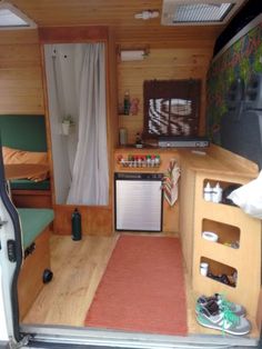 the interior of a small camper with wood paneling