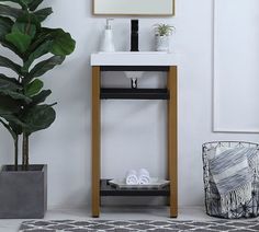 a bathroom with a plant, sink and mirror on the wall next to a rug