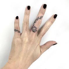 a woman's hand with tattoos on it