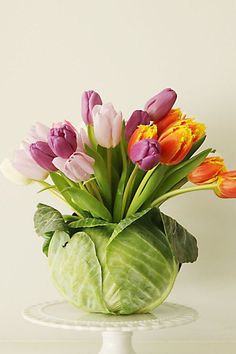 a vase filled with lots of colorful flowers