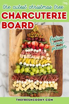 the cutest christmas tree charcute board is made with cheese, fruit and meats