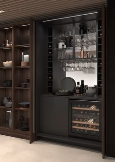 an open wine cabinet with many bottles and glasses