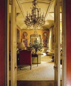 a living room filled with furniture and a chandelier