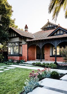 a brick house with landscaping in front of it