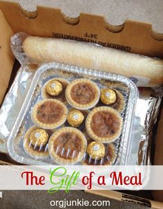 the gift of a meal includes mini pies and a pastry in a cardboard box