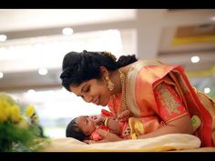 a woman holding a baby in her lap