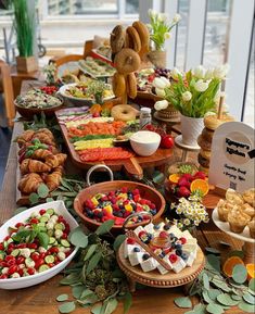 a table filled with lots of different types of food and desserts on top of it