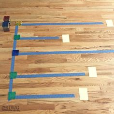 some tape is taped to the floor with blue tape and two small pieces of tape