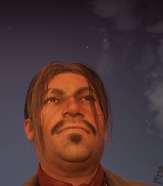 a man with long hair and a moustache looks up at the night sky