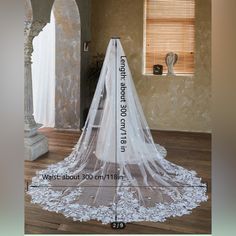 a wedding veil is on display in front of a window