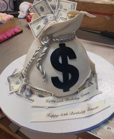 a birthday cake made to look like a money bag