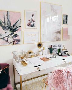 a white desk topped with lots of pink and gold furniture next to pictures on the wall