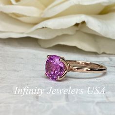 "This ring is a round cut lab created pink sapphire solitaire in 14k rose gold #6465 -Approximate total carat weight: 2.70ctw. diamond equivalent -Center Stone Size: approx. 2.70ct diamond equivalent -Center Stone Shape: round cut / 9 MM -Gem Type: lab created pink sapphire -Stone Clarity: VS2 -Stone Color: Medium Pink -Moh's Scale: 9 hardness -Metal Type and Purity: 14k rose gold -Setting: classic Tulip 4 Prong Setting -Stock Ring Size: 6 -Country of Manufacturing: USA (Michigan) For customizat Fine Jewelry Pink Sapphire Ring, Pink Brilliant Cut Round Ruby Ring, Pink Brilliant Cut Ruby Ring, Pink Sapphire Ring Birthstone Fine Jewelry, Pink Round Cut Ruby Ring In Fine Jewelry Style, Pink Gold Sapphire Ring Fine Jewelry, Fine Jewelry Pink Gold Sapphire Ring With Pink Sapphire, Fine Jewelry Pink Ruby Ring With Round Cut, Pink Ruby Ring Fine Jewelry Birthstone