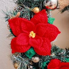 a crocheted christmas wreath with poinsettia