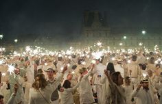 a large group of people holding sparklers in their hands