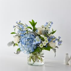 a vase filled with blue and white flowers