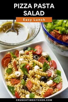 a pasta salad with tomatoes, olives and mozzarella