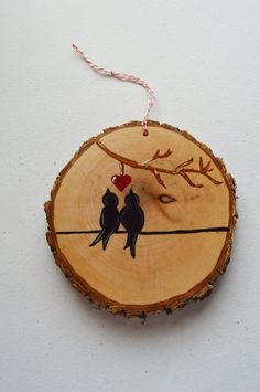 two birds are sitting on a tree slice