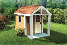 a small wooden shed sitting on top of a green grass covered field next to a tree