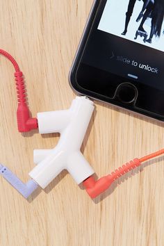 two ear buds connected to an iphone on a table