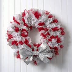 a red and white wreath hanging on the wall