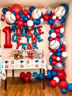 a baseball themed birthday party with red, white, and blue balloons on the wall