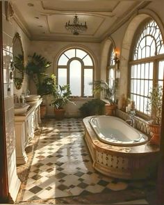 a large bathroom with an arched window and tiled floor, along with a jacuzzi tub in the center