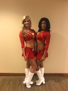 two women dressed in red and white posing for the camera