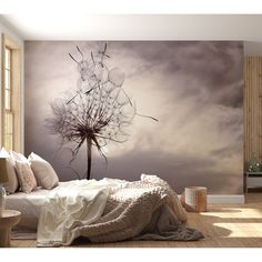 a dandelion in the middle of a room with a large window and wall mural