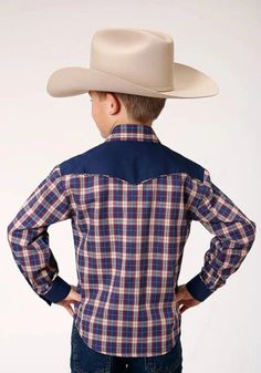 Boy's Long Sleeve Shirt Curved 1 Point Back Yoke Plaid Cotton/Poly Broadcloth Body Pieced w/Solid C/P Yokes and Cuffs Trimmed w/Self Piping Smile Pockets w/Arrow Points 1 Snap Cuff 55% Cotton / 45% Polyester The Roper Little Trailblazer (Blue) Boys Western Shirt is a vibrant and stylish addition to any young adventurer's wardrobe. Featuring a charming plaid design with shades of navy, red, and cream, this shirt offers a playful yet classic look. The colors blend seamlessly, creating a striking contrast that makes the shirt stand out. Featuring smile pockets with arrow points and 1 snap cuff, this shirt combines functionality with style. Made from 55% Cotton and 45% Polyester, it offers durability and comfort, ensuring your little one stays cozy throughout the day. Perfect for any occasion, Classic Blue Tops For Rodeo, Boys Long Sleeve Shirts, Western Shirt, Plaid Design, Boys Long Sleeve, Western Shirts, Long Sleeve Shirt, Classic Looks, Sleeve Shirt