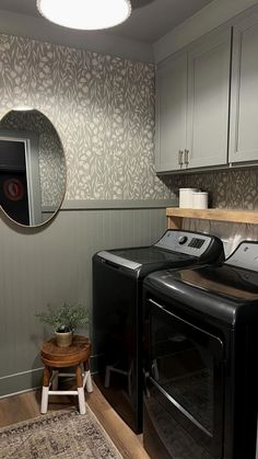 a washer and dryer sitting in a room next to each other on top of a rug