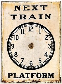 an old clock with the words next train on it's face and numbers below