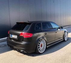 an audi car parked in front of a building