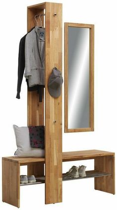 a wooden coat rack with mirror and shoes