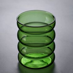 three green glass bowls stacked on top of each other