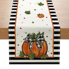 a black and white table runner with pumpkins on it